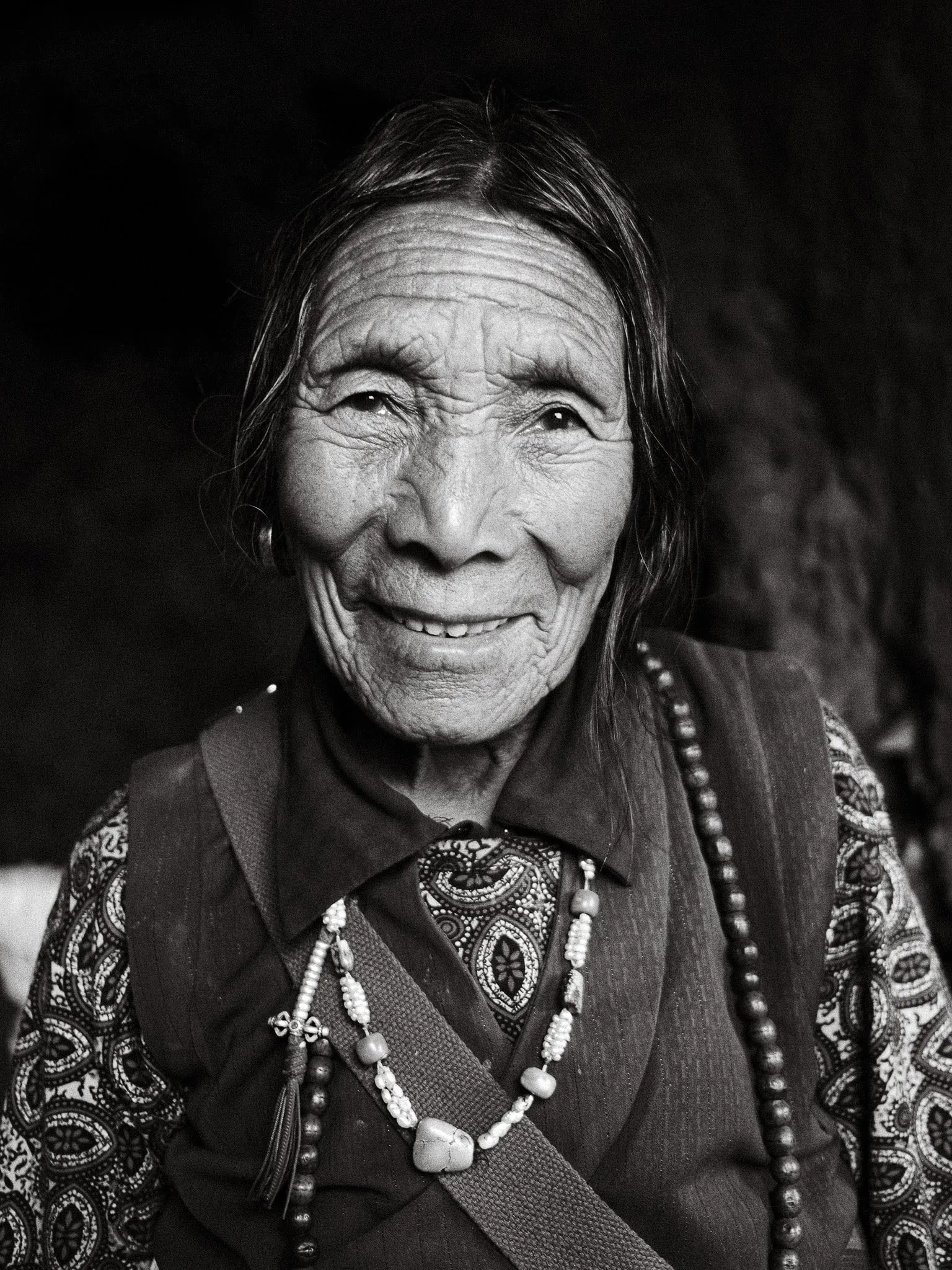 A black and white portrait photo of an elderly Nepali woman in Upper Mustang, Nepal