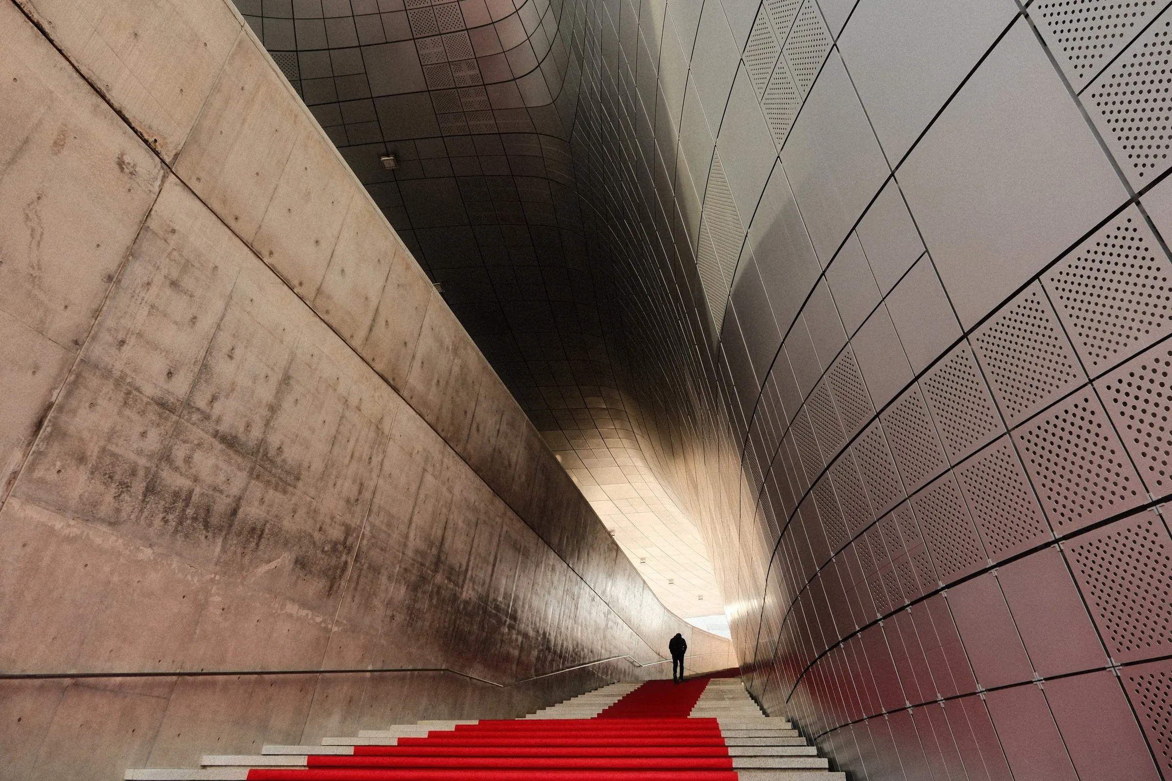 A man walks up the steps at Dongdaemun Design Plaza in Seoul