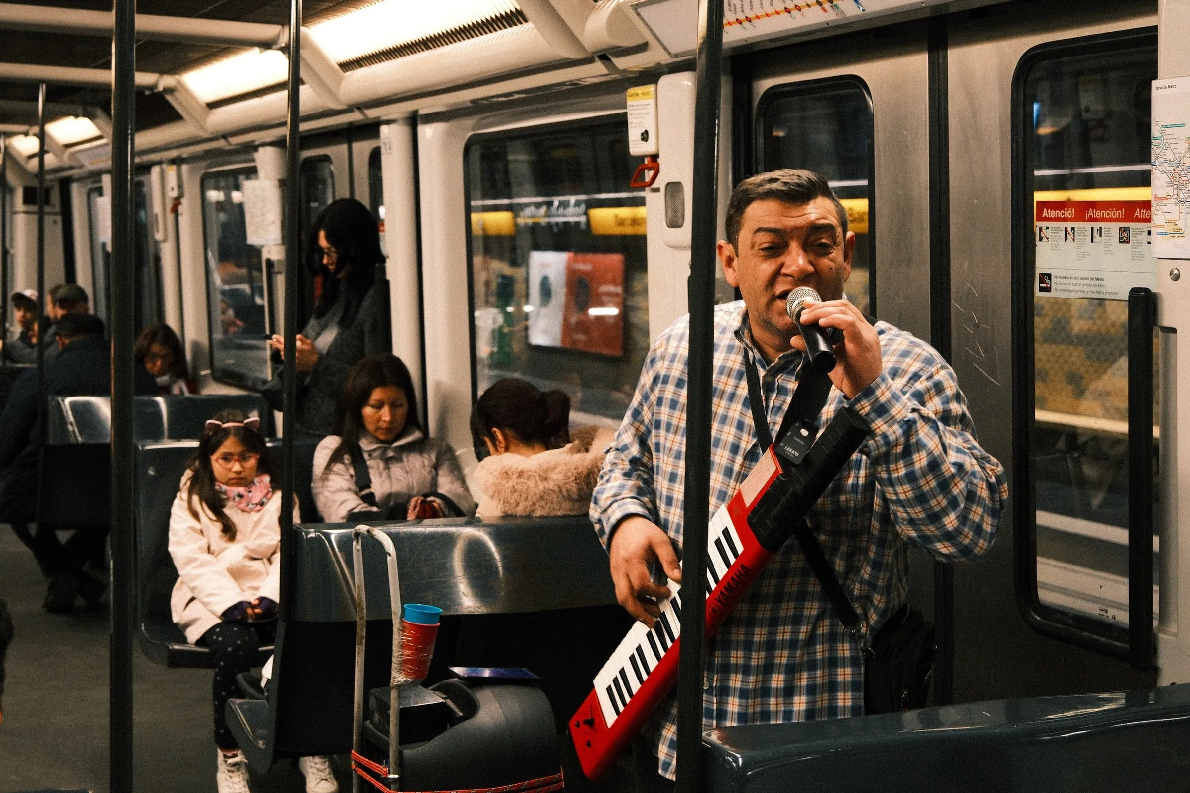 A performer sings on the metro