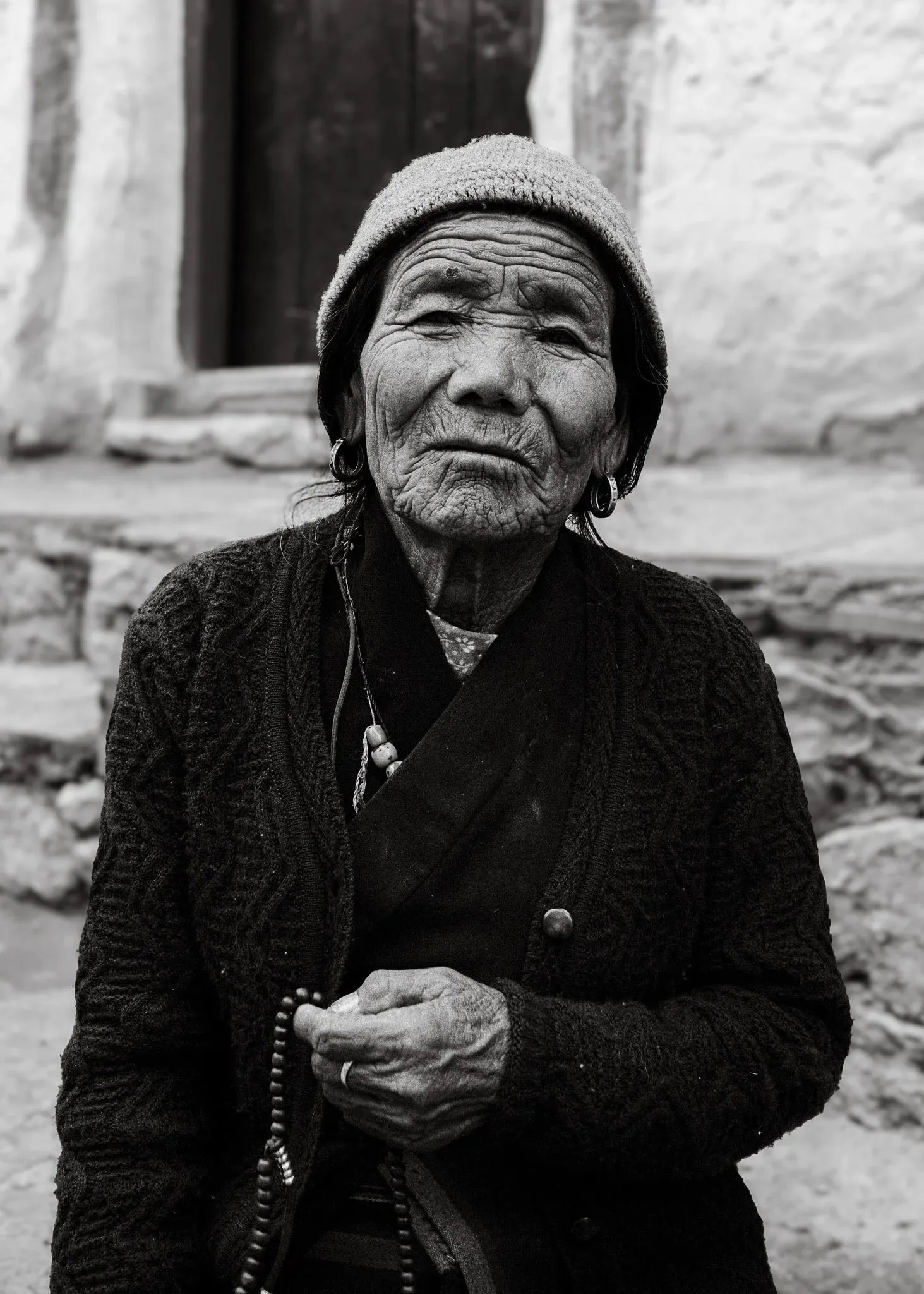 Black and white photo of an elderly woman in Lo Manthang, Upper Mustang, Nepal