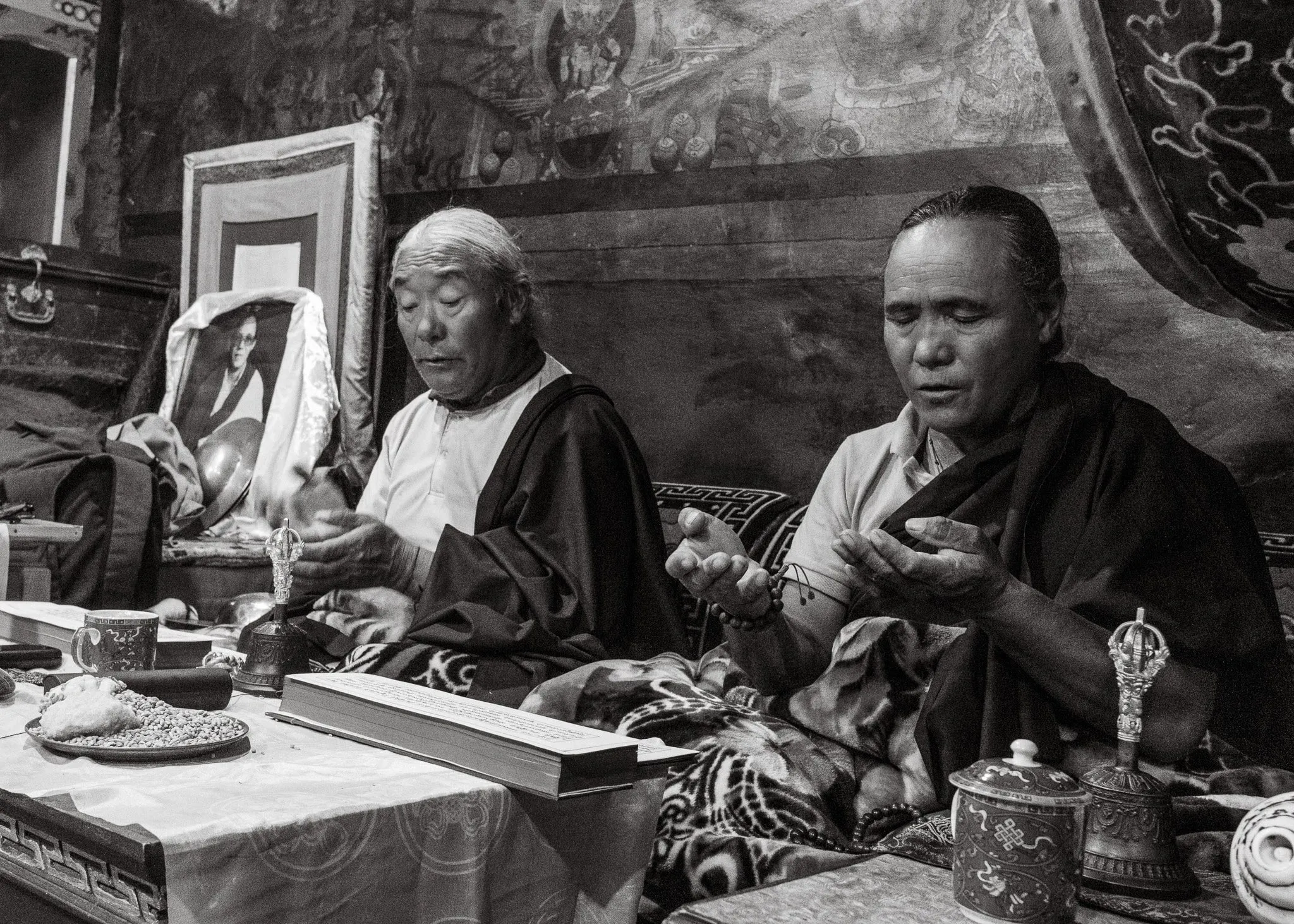 Black and white photo of monks performing a puja ceremony at Luri Gompa in Upper Mustang