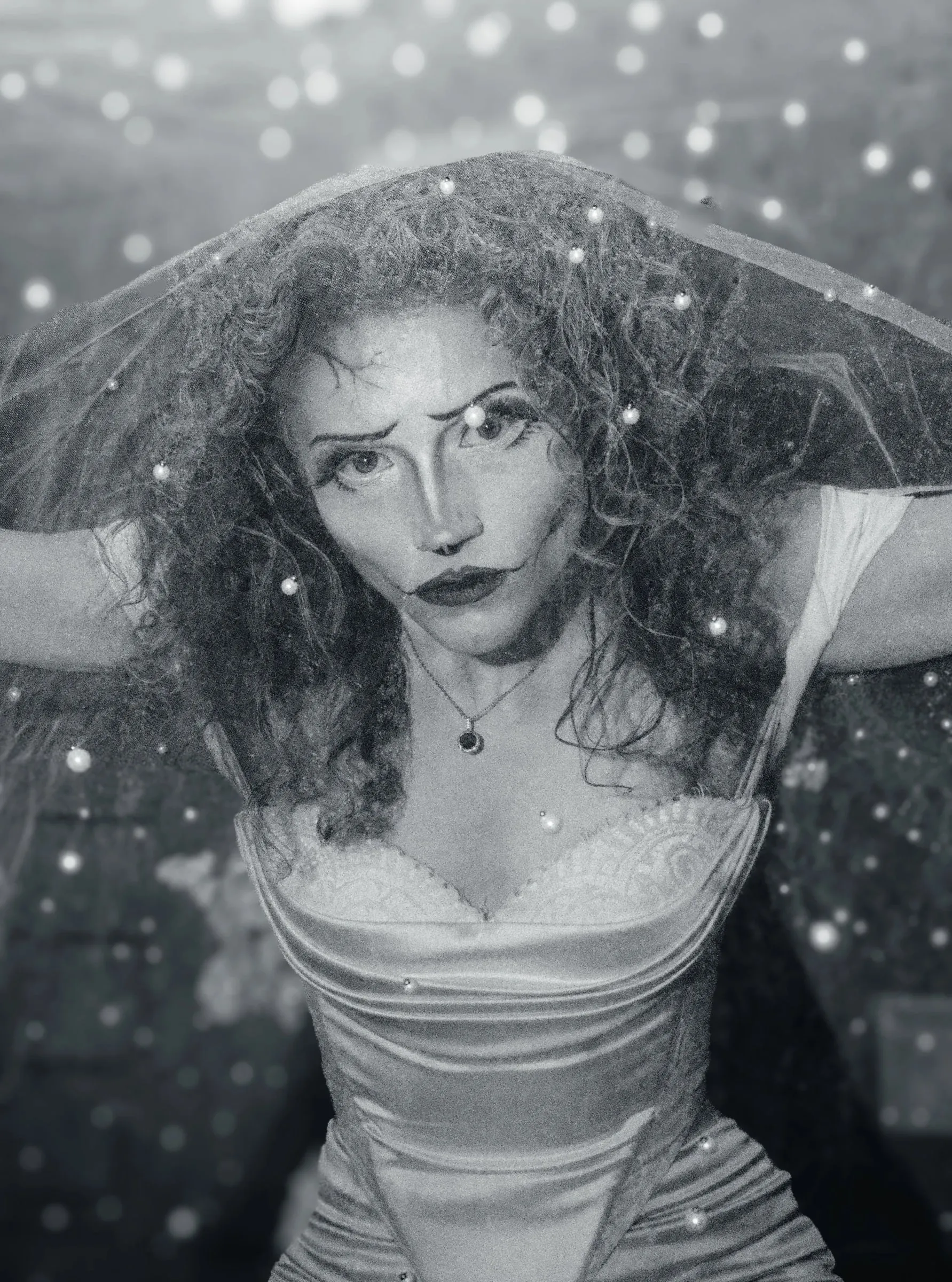 Black and white portrait of a woman dressed as the Corpse Bride, with a veil and curled hair