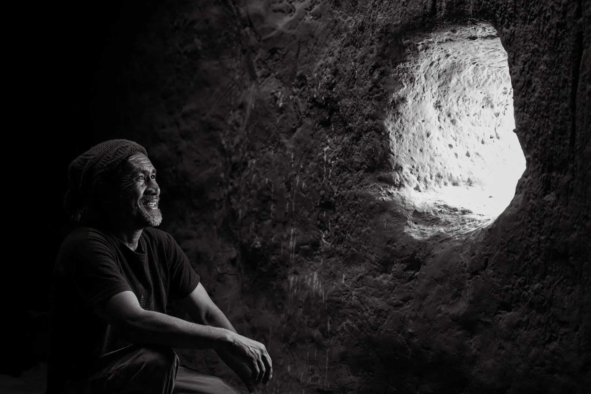 Environmental portrait of a man in a cave in Upper Mustang, Nepal