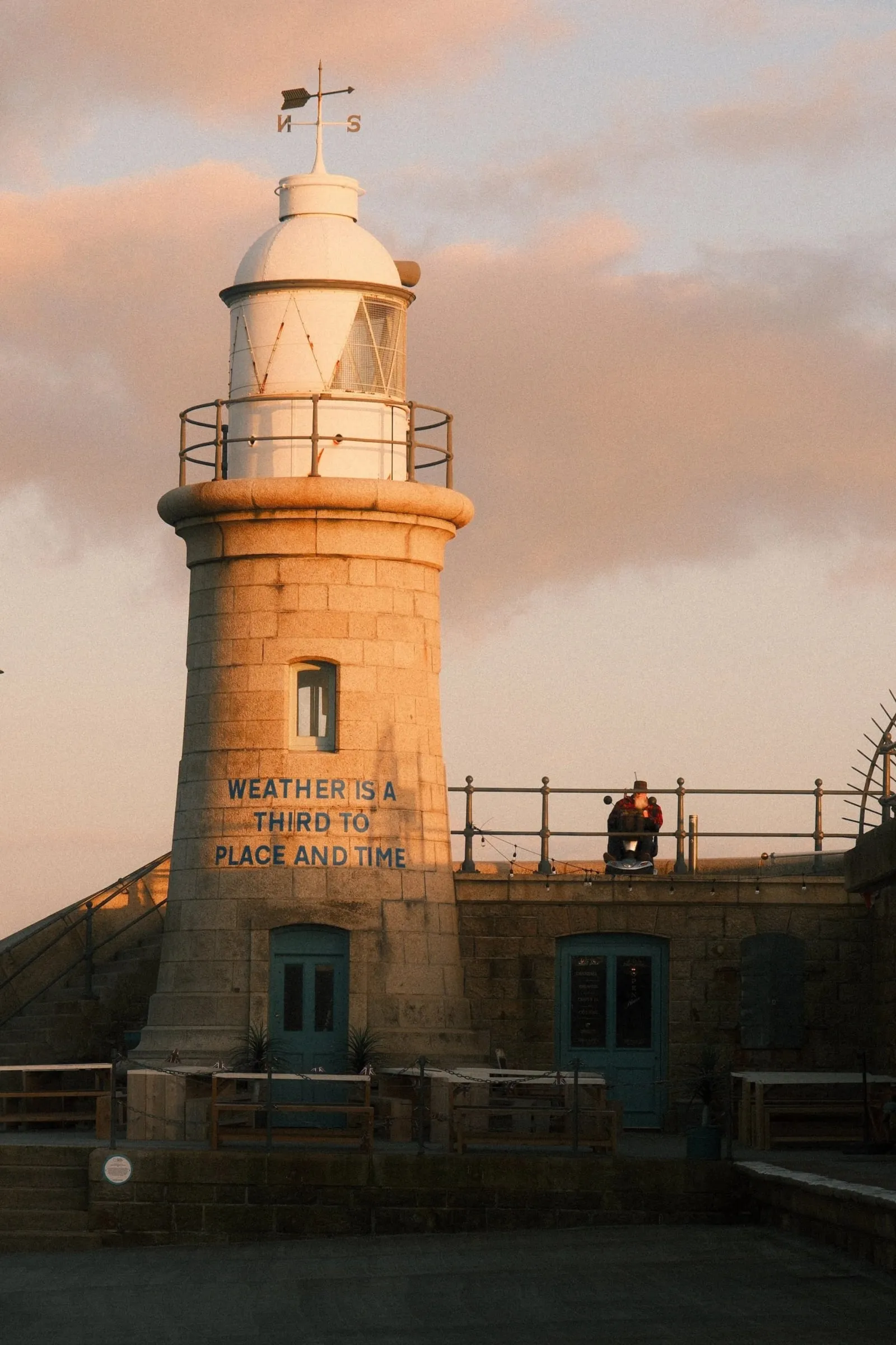 The lighthouse at the end of Folkestone Harbour Arm in warm evening light