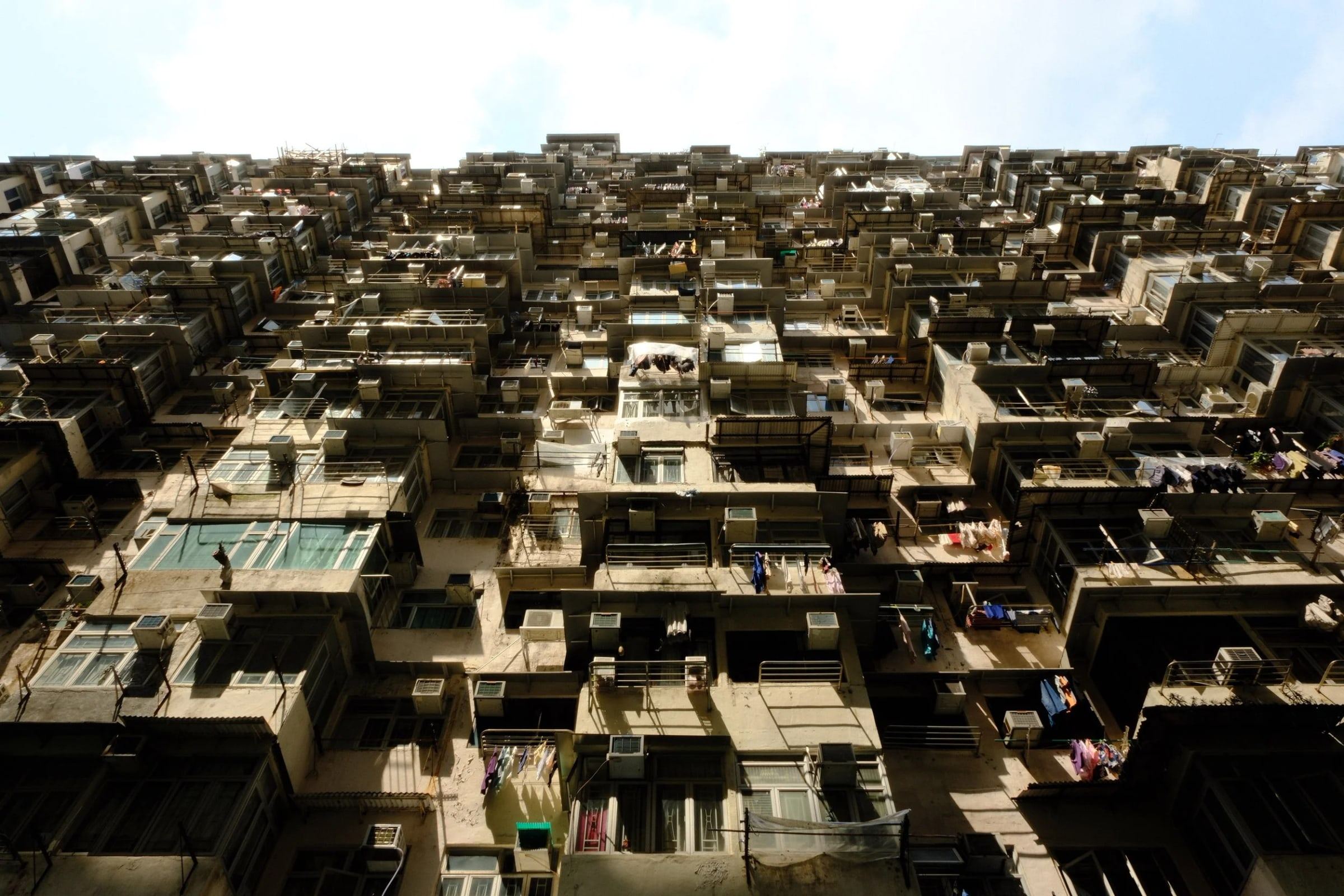 Looking up at tightly packed apartment blocks