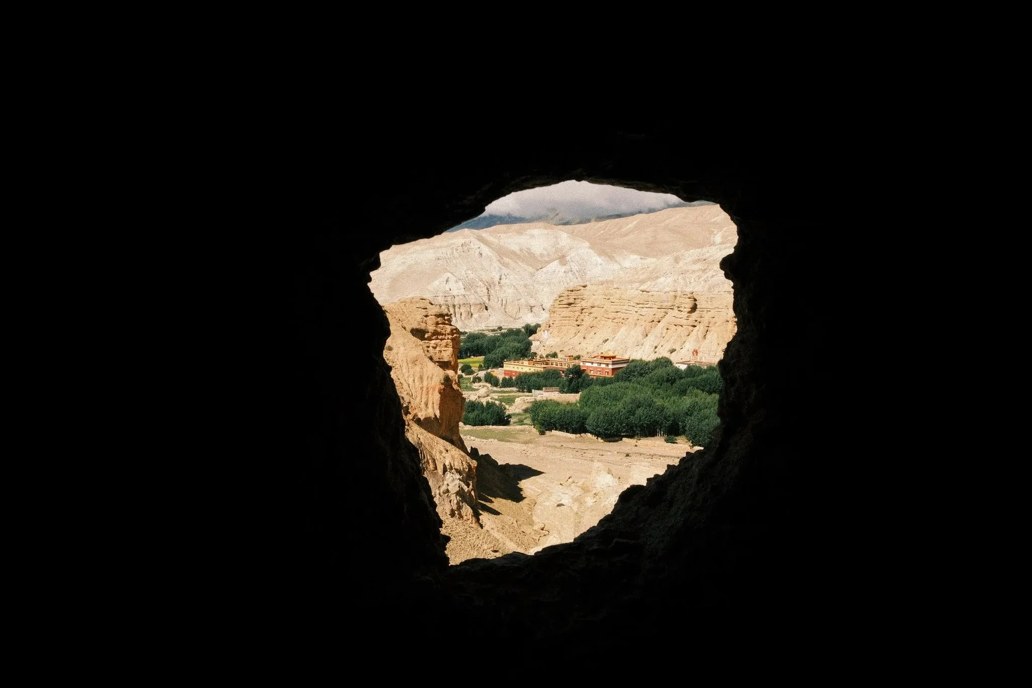 Image of a monastery in Choser, through the window of a cave