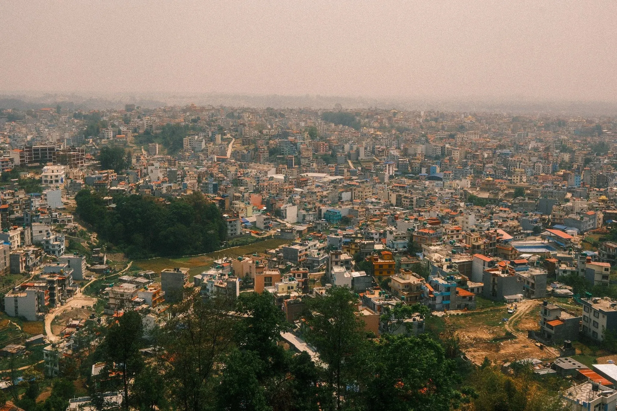 Kathmandu spreading across the valley in haze, seen from the hill at Kopan