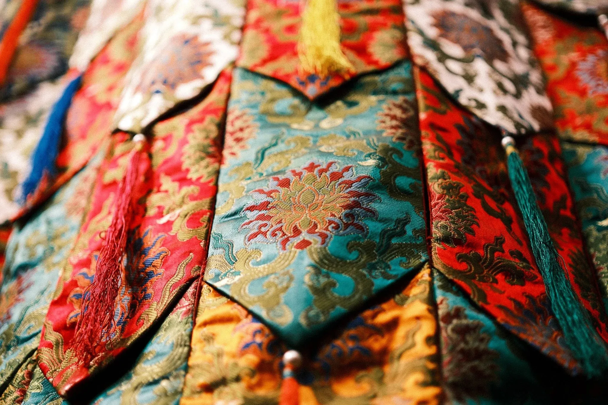 Close-up of colourful brocade banners hanging in the monastery at Lubra