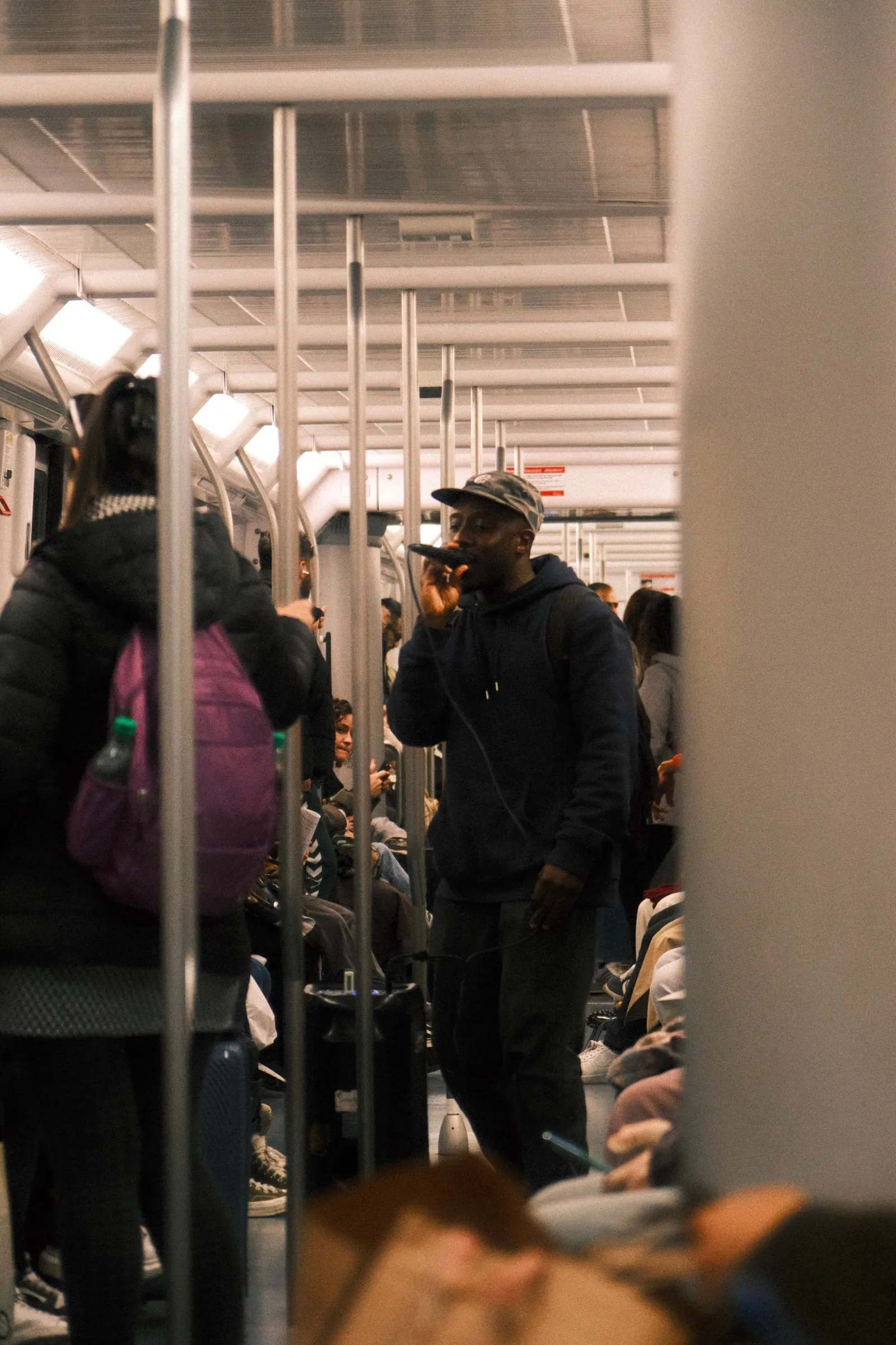 A man sings in a busy metro carriage in Barcelona