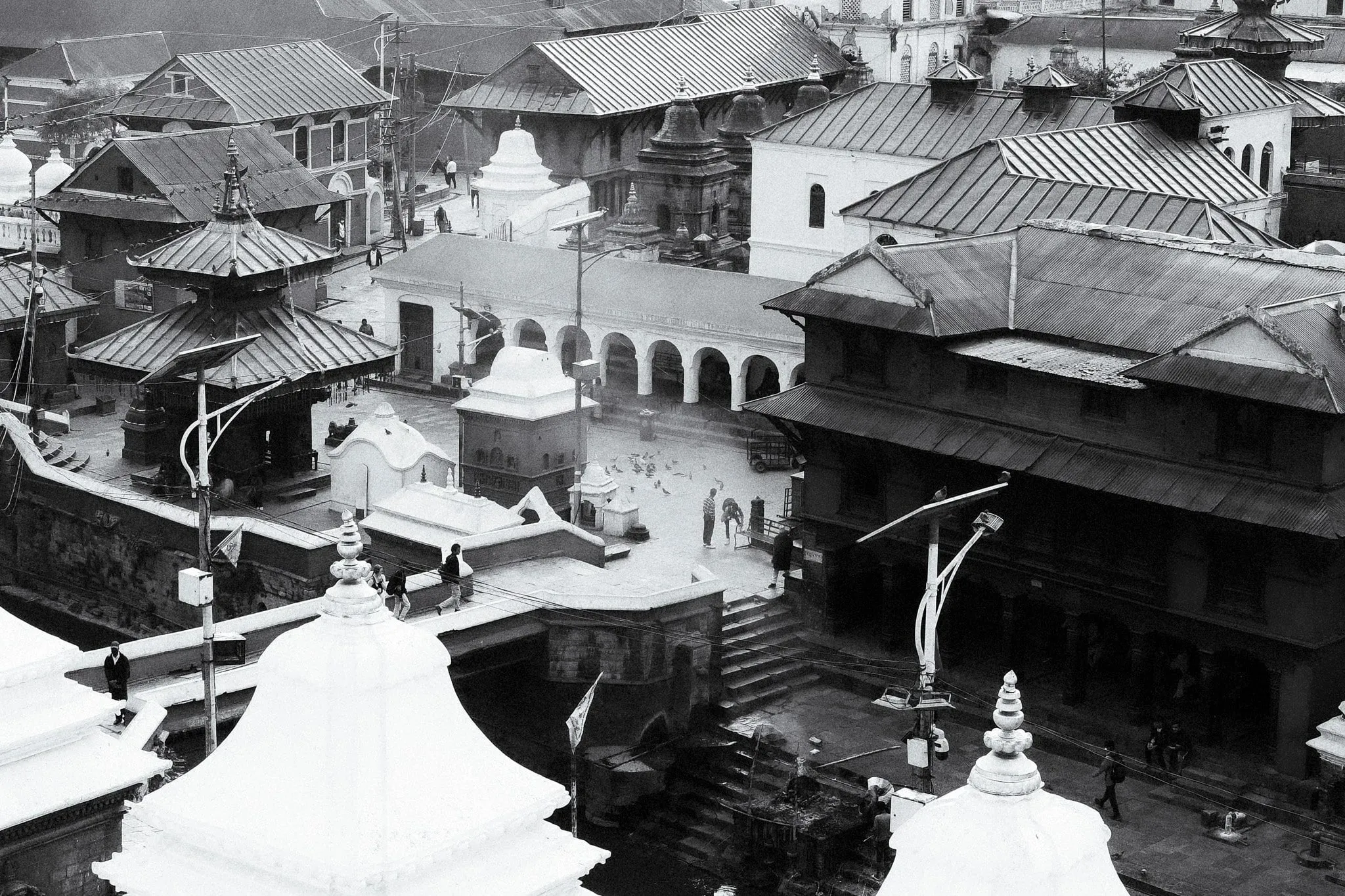 Black and white photo of temple roofs and courtyards at Pashupatinath from above