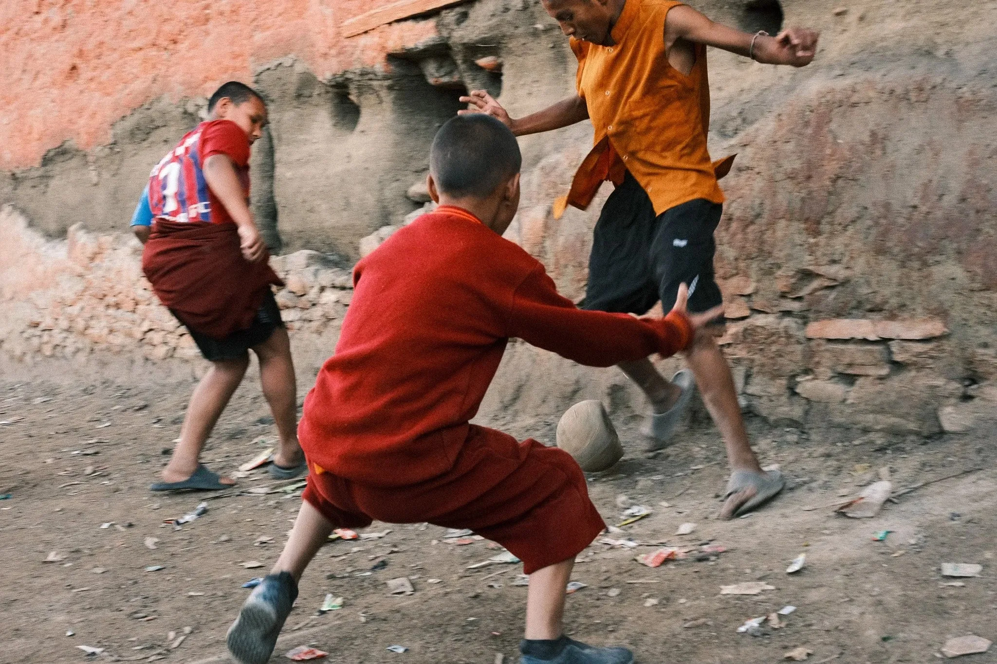 Photo of young monks playing football in Lo Manthang, Upper Mustang, Nepal