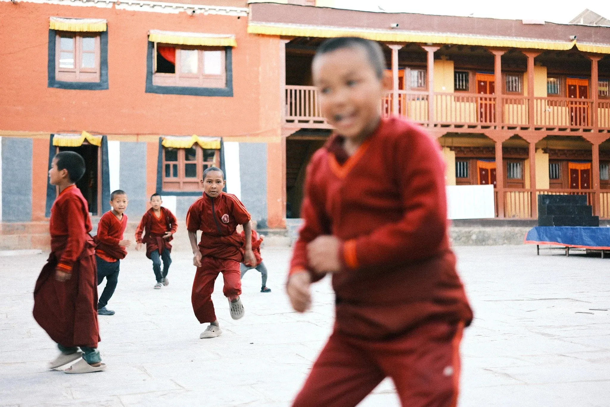 Photo of young monks playing in the courtyard of a monastery in Lo Manthang, Nepal