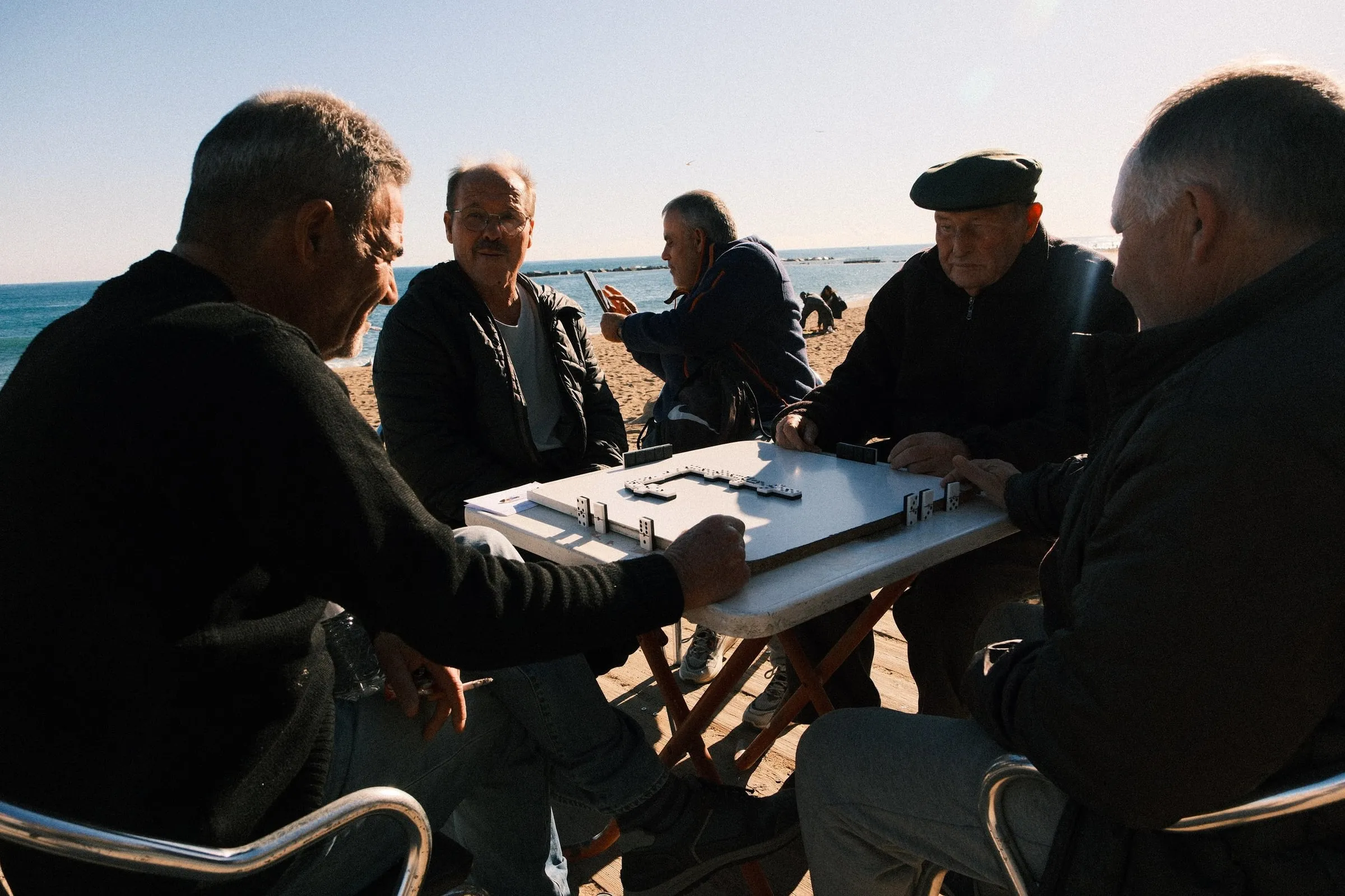 Photographing locals playing dominoes at the beach in Barcelona