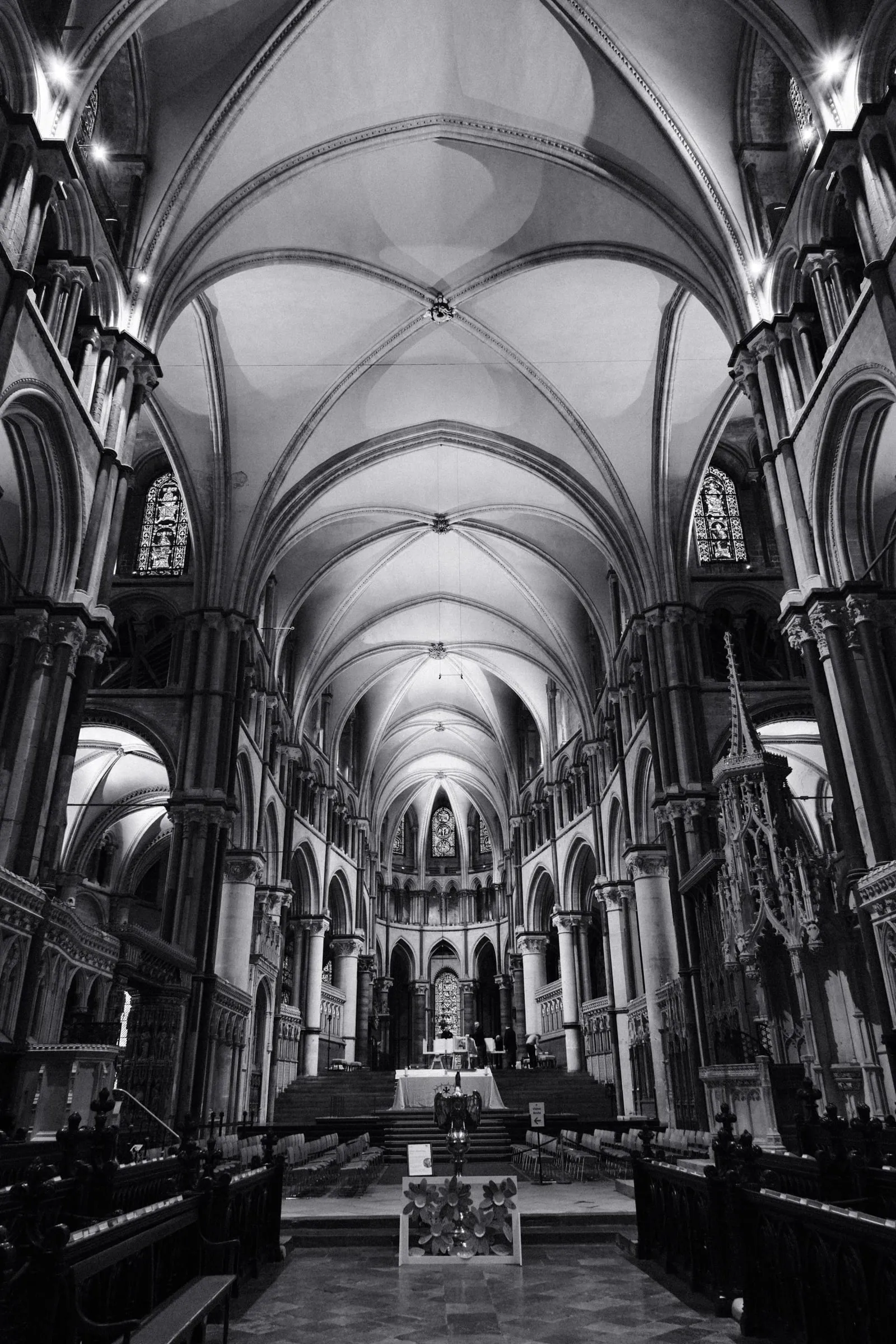 Black and white photo of the vaulted quire, looking towards the altar