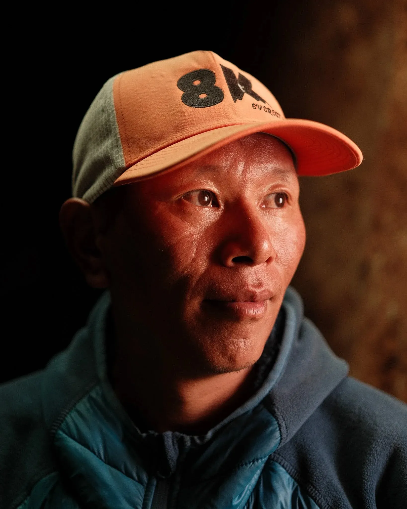 Portrait of a man in an orange cap looking off to one side